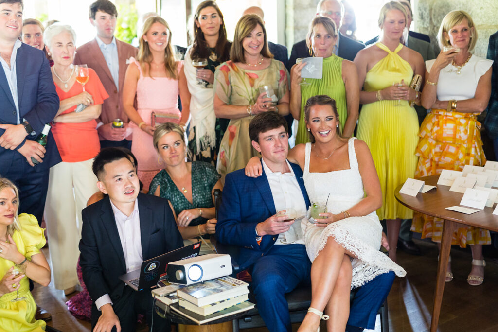 Bride and Groom sitting in chairs surrounded by family and friends at Skyline Lodge in Highlands, NC