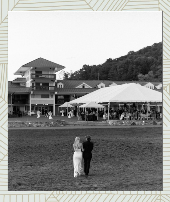 Bride and groom walking toward reception tent