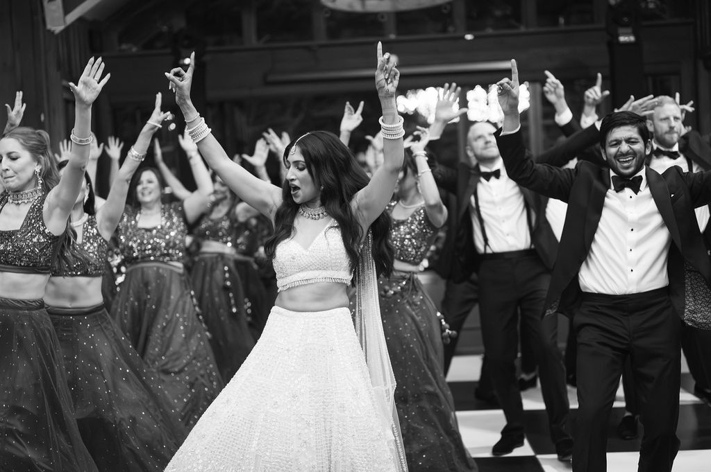 Black and white photo of bride and groom dancing with guests at their wedding reception at The Farm at Old Edwards Inn, Highlands NC